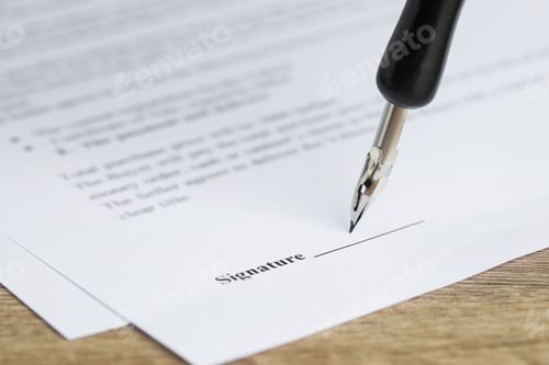 Preview: Signing notary document with fountain pen at wooden table, selective focus
