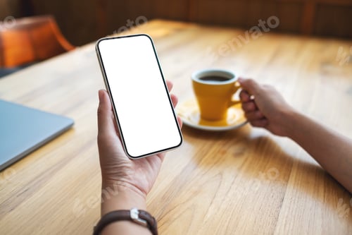 Preview: Mockup image of a woman holding mobile phone with blank desktop screen while drinking coffee