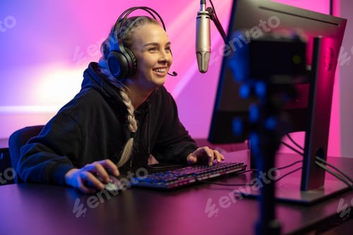 Smiling Woman Playing Video Games on Computer