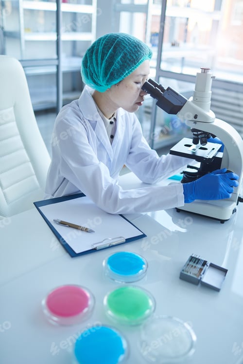 Preview: Female Asian Scientist Using Microscope