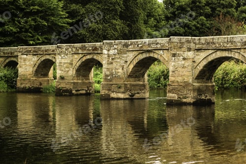 Preview: Beautiful shot of the old Essex Bridge with green trees in the distance in Shugborough UK.