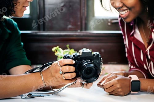 Preview: Women inspecting a camera