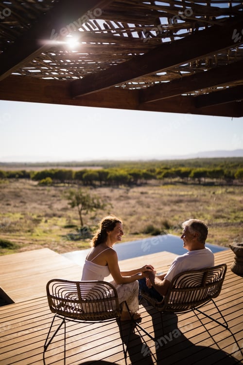 Senior couple sitting on chairs at the resort