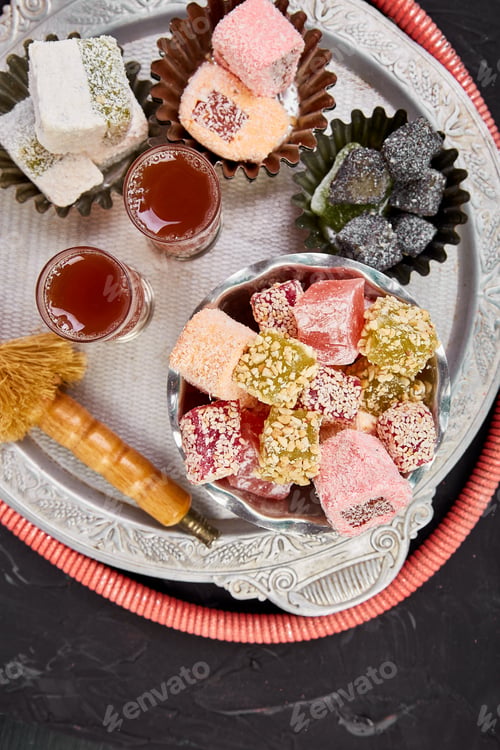 Preview: Set of various Turkish delight in bowl on metal tray near hookah tube