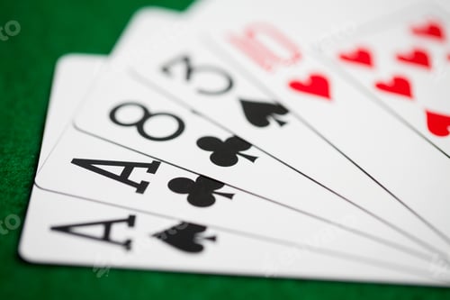 Preview: poker hand of playing cards on green casino cloth