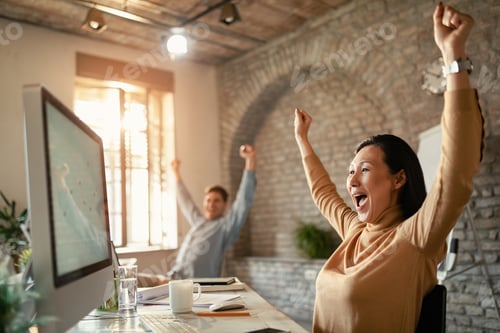 Preview: Cheerful Asian Businesswoman With Arms Raised Celebrating Getting Good News Over Computer In The