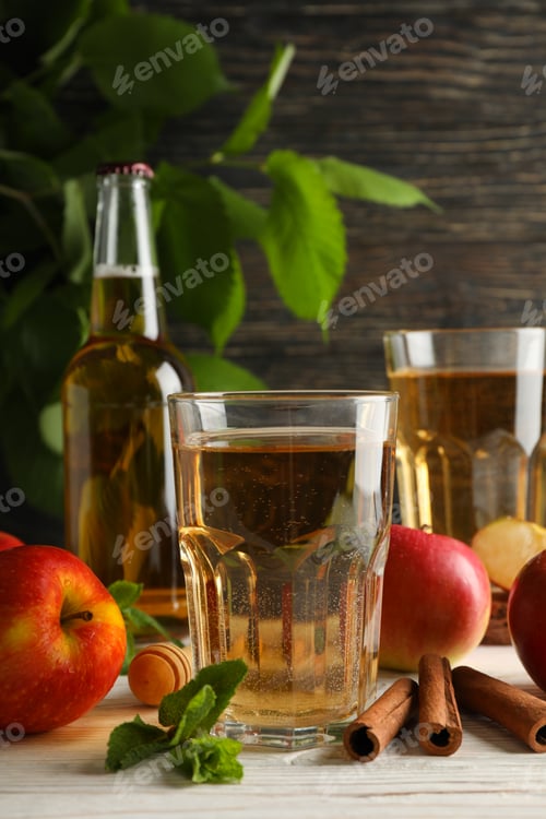 Preview: Composition with cider, cinnamon and apples on wooden background