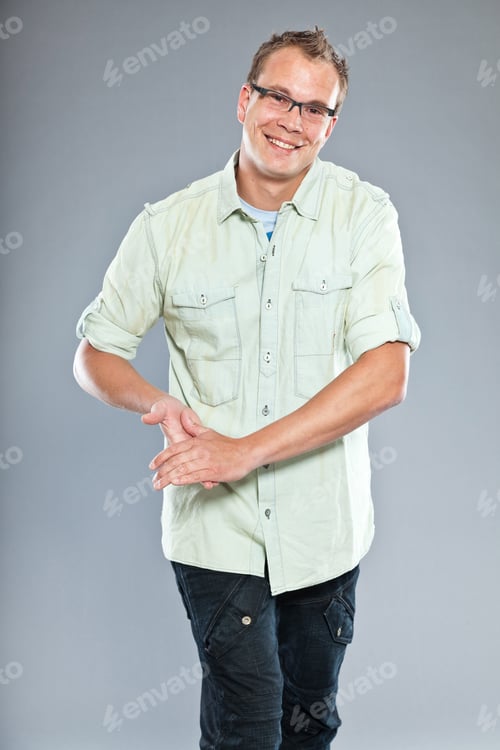Preview: Happy Young Man With Short Hair Wearing Light Green Shirt And Blue Jeans. Wearing Glasses. Sportive