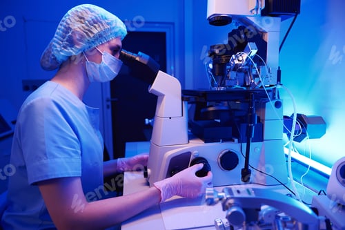 Preview: Serious embryologist is carrying out ICSI with micromanipulator in laboratory