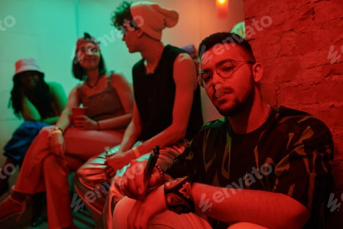 Preview: Young multiethnic man vaping in club