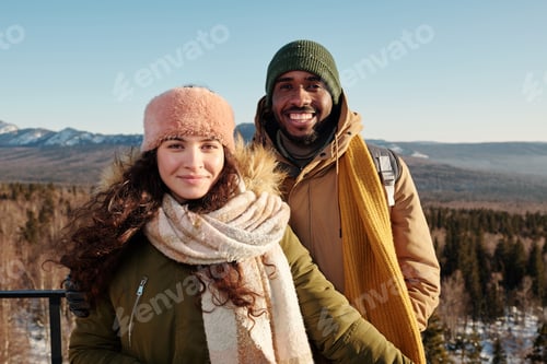 Preview: Happy young intercultural couple spending winter day outside