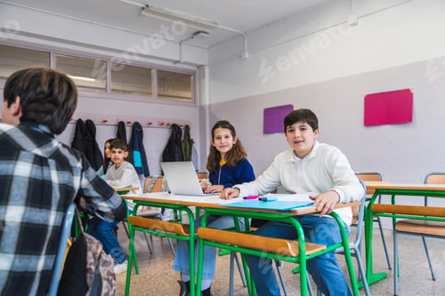 Preview: Students using laptop computer during class at school