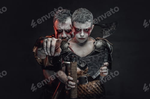 Preview: Tribal father warrior pointing a finger at camera in studio