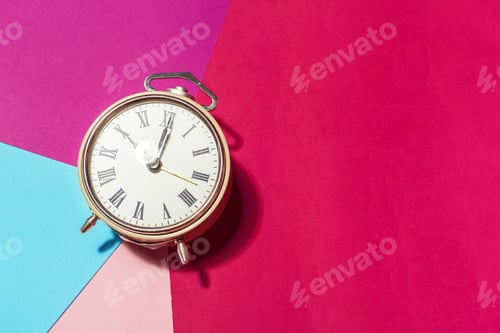 Preview: Artistic arrangement of a vintage clock on colorful paper background