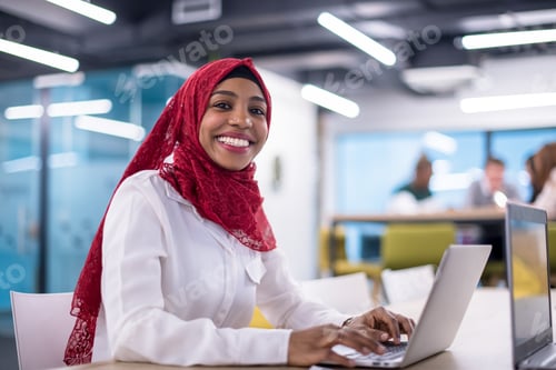 Preview: black muslim business woman ,working on laptop computer
