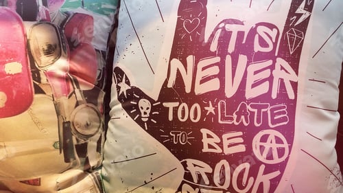 Preview: Sofa cushion with words ‘It’s never too late to be a rock star’