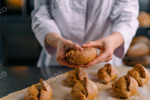 Preview: baker showing hot cut freshly baked crispy and puffy bread bun bakery