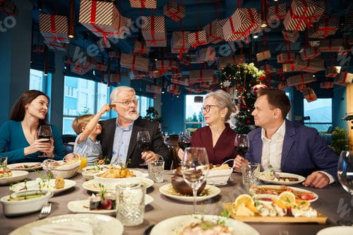 Preview: Little boy having fun with aged man celebrating New Years Eve