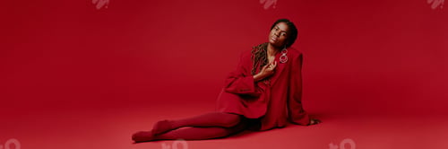 Preview: Sitting Woman Wearing Red Fashionable Outfit Posing Confidently