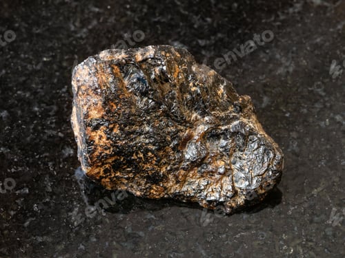 Preview: rough Cassiterite (Tin ore) stone on black