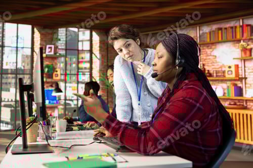 Preview: Customer center supervisor overseeing intern assisting clients