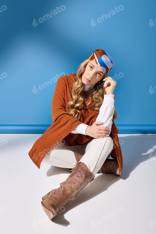Preview: Charming young plus size woman in stylish outfit poses gracefully against vibrant blue backdrop