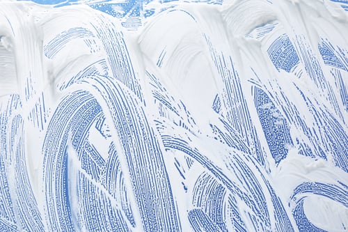 Preview: Cleaning foam on window glass, closeup view