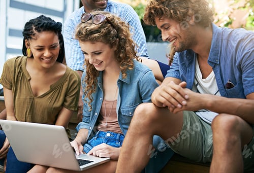 Preview: Shot of a group of students sitting with a laptop on campus