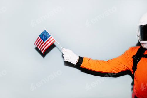 Preview: Hand of an astronaut holding the flag of the United States of America