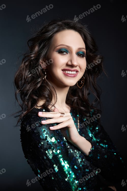 Preview: Beauty portrait of a woman with beautiful evening makeup, a brunette girl in a shiny evening dress