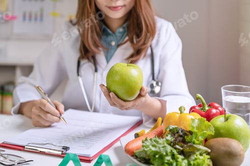Preview: Nutritionist giving consultation to patient with healthy fruit and vegetable