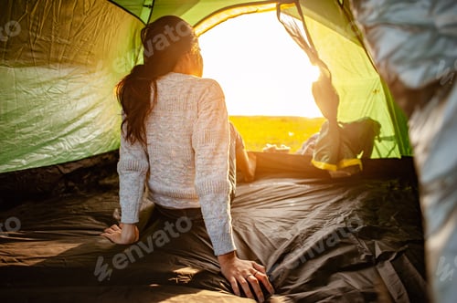 Preview: The woman asian who just woke up inside the tent was watching the sunrise in the morning