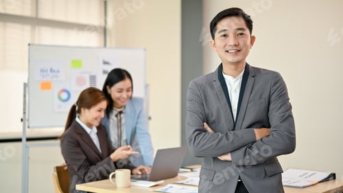 Preview: A confident Asian businessman or male CEO stands in the meeting room with his arms crossed.