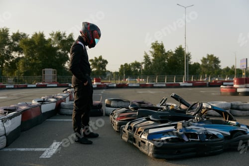 Preview: A professional drive racer is posing with cars near at the race