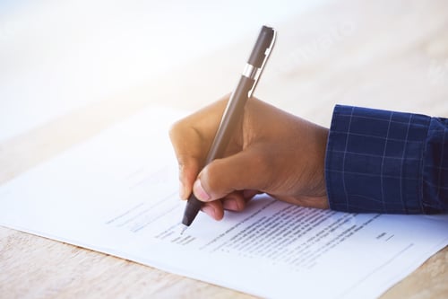 Preview: Shot of an unrecognizable businessman filling in a form on a desk in an office
