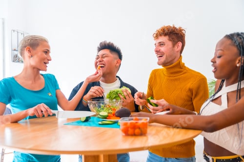 Preview: Group of friends preparing vegetarian food. Preparing the salad and having fun in the kitchen