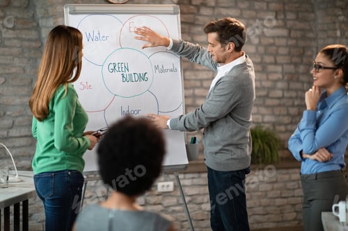 Preview: Entrepreneur giving presentation to his coworkers on a meeting in the office.