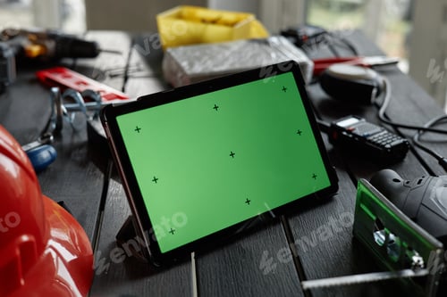 Preview: Digital Tablet with Green Screen Displaying on Construction Work Table