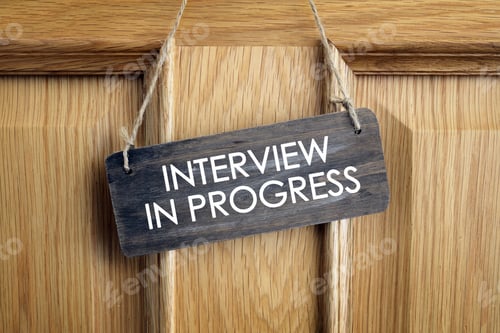 Preview: Interview in progress sign on office door