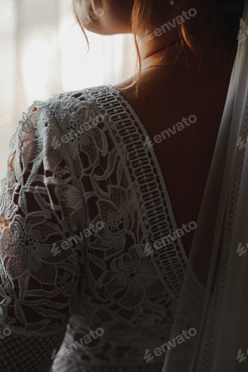 Preview: Bride in a apartment in a wedding dress. Bride looks out of the window, wedding day.