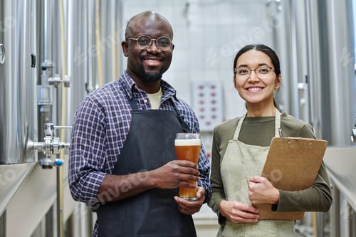 Preview: Couple of brewers degustating beer in brewery