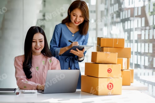 Preview: Two Young Asian women are happy and excited after a new order from SME customer, commercial checking