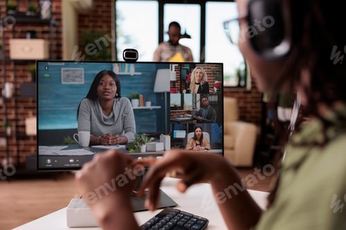 Preview: Closeup of african american freelancer with wireless headphones in online interview with startup
