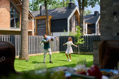 Preview: Joyful mother and father are having fun playing with their son