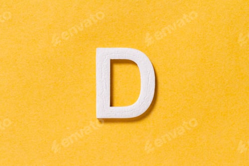 Preview: Letter D of the alphabet isolated on yellow background, top view