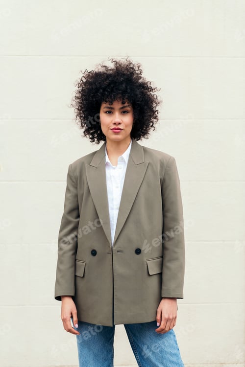 Preview: business woman with curly hair wearing a blazer