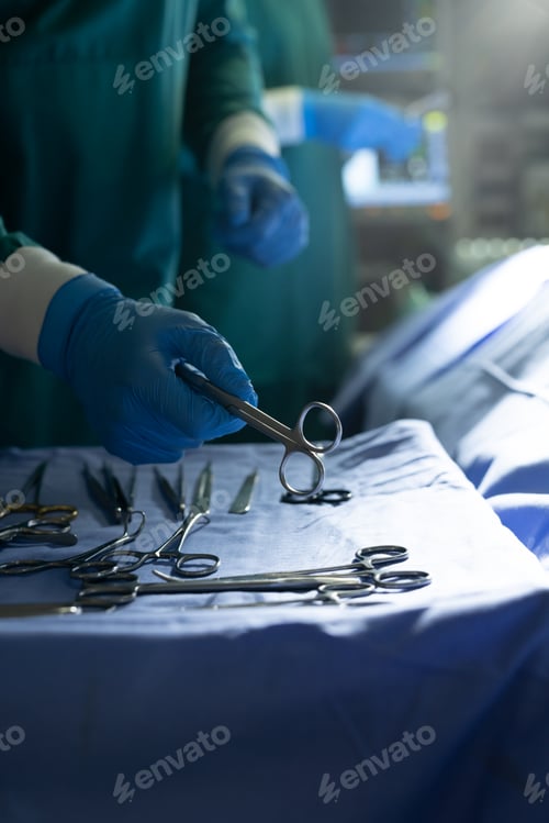 Preview: Vertical of midsection of surgical tech preparing instrument for surgeon in theatre, with copy space