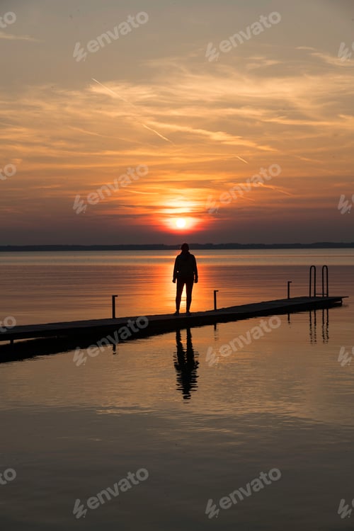 Preview: a beautiful red and orange sunset at a lake in Germany