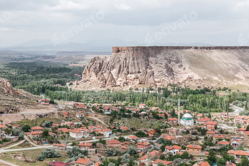 Preview: majestic landscape with bizarre rock formations and buildings in cappadocia, turkey