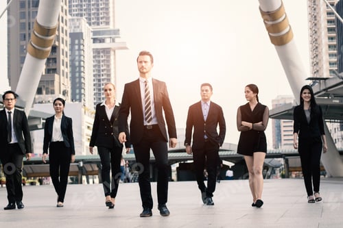Preview: businesspeople team of multi ethnic walking with confidence in full suit